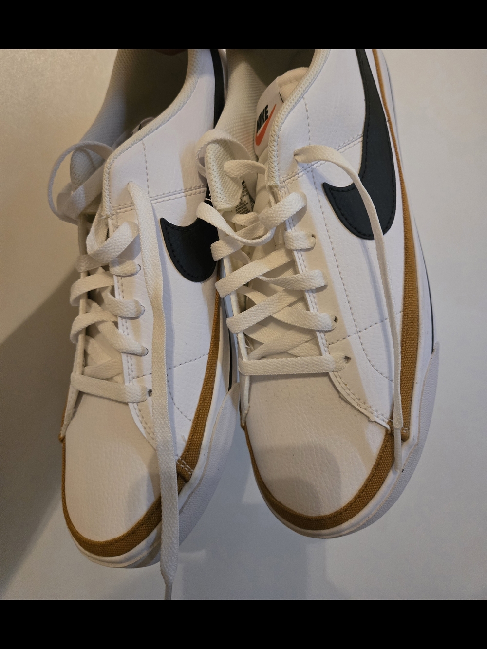 Nike White Sneakers with Black Swoosh and Gold Trim